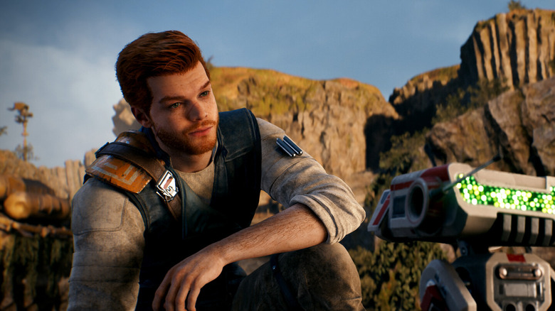 Cal kneeling and looking at a droid in Star Wars Jedi: Survivor (2023)
