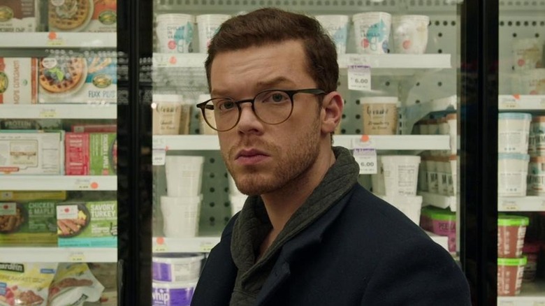 Chris standing in front of a store freezer in Shattered (2022)