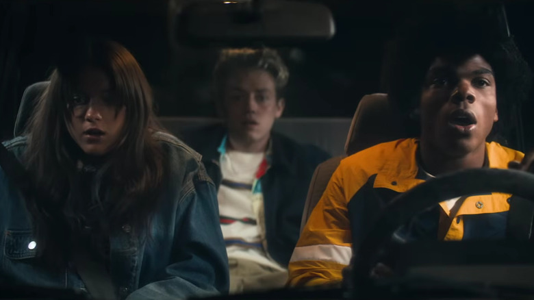 Cora, Otis, and Jaden in a car looking shocked in Going Places