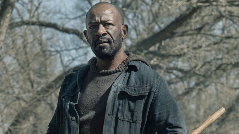 Morgan carrying his bo staff in the woods