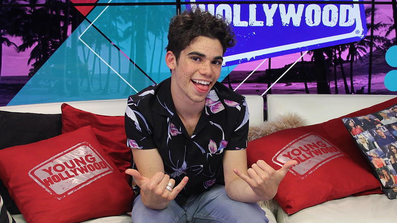 Cameron Boyce smiling on couch
