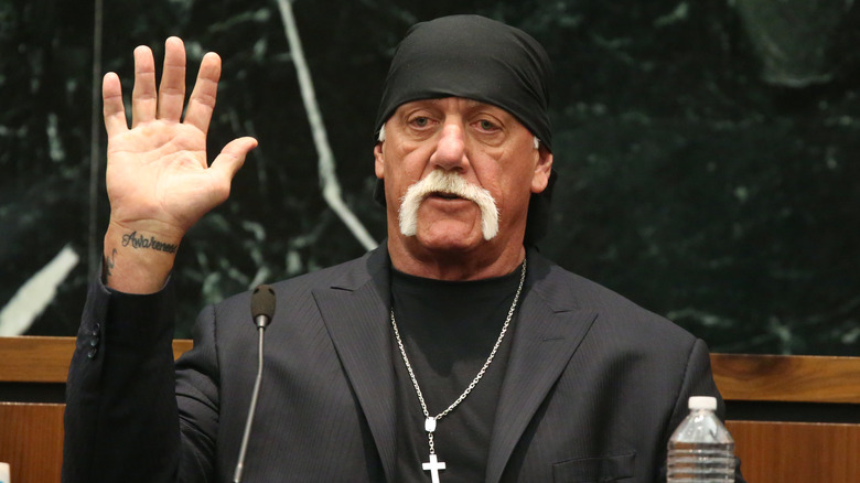 Hulk Hogan raises his hand in court