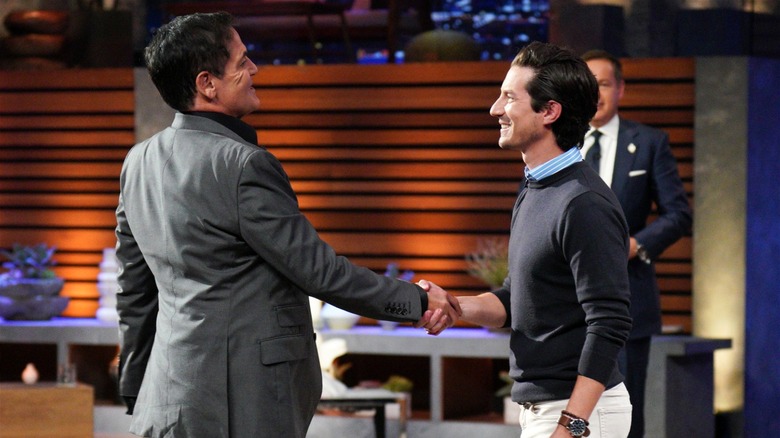 Justin Baer shaking hands with Mark Cuban