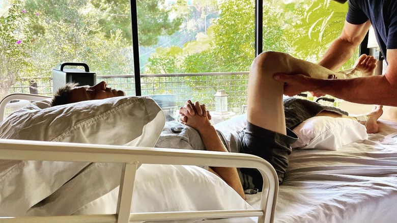 Jeremy Renner undergoing rehab in a hospital bed