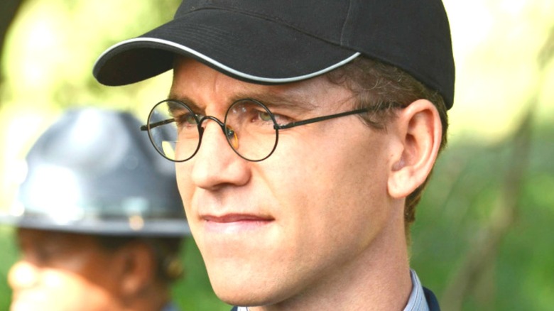 Brian Dietzen as Jimmy Palmer wearing a hat and Harry Potter glasses on NCIS