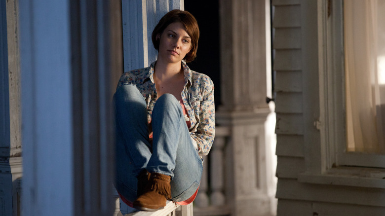 Maggie sitting on porch railing in 