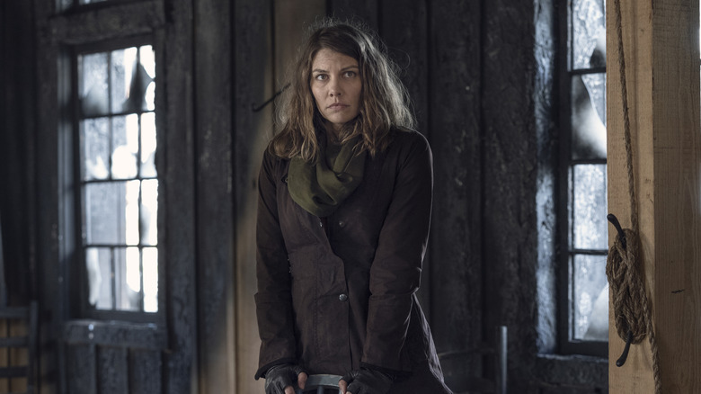 Maggie standing behind a chair in "The Walking Dead"