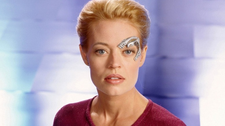 Jeri Ryan posing for a photo as Seven of Nine in a "Star Trek: Voyager" promo shot