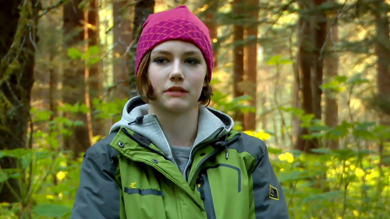 Rain Brown stands in the forest in "Alaskan Bush People" (2014-2022)