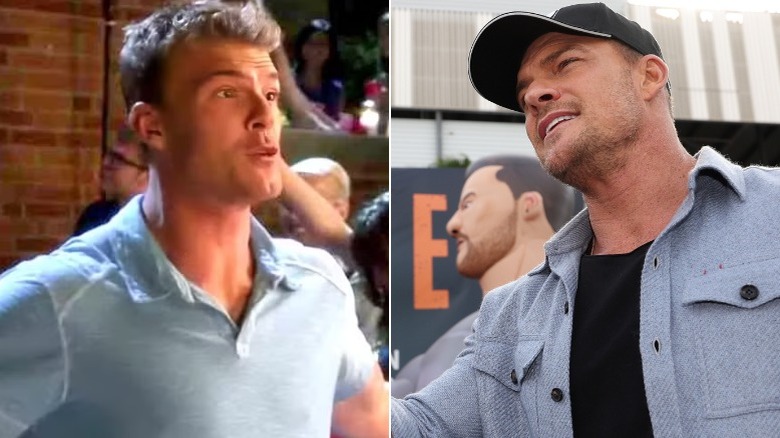 Thad Castle next to Alan Ritchson at Daytona 500  promo event outdoors pointing with Reacher banner behind