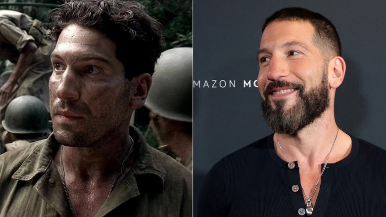 Rodriguez walks through camp in the jungle, Jon Bernthal smiles