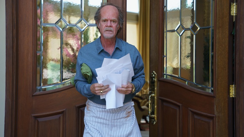 Richard Fuisz holding mail in an apron