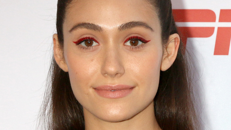 Emmy Rossum smiling on red carpet