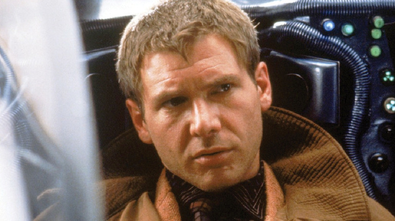Rick Deckard sits in a vehicle in Blade Runner