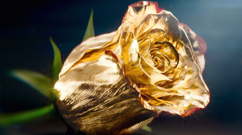 A rose covered in gold to promote The Golden Bachelor