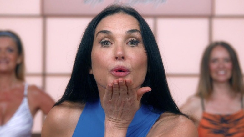 Elizabeth blows a kiss on her exercise show in "The Substance" (2024)