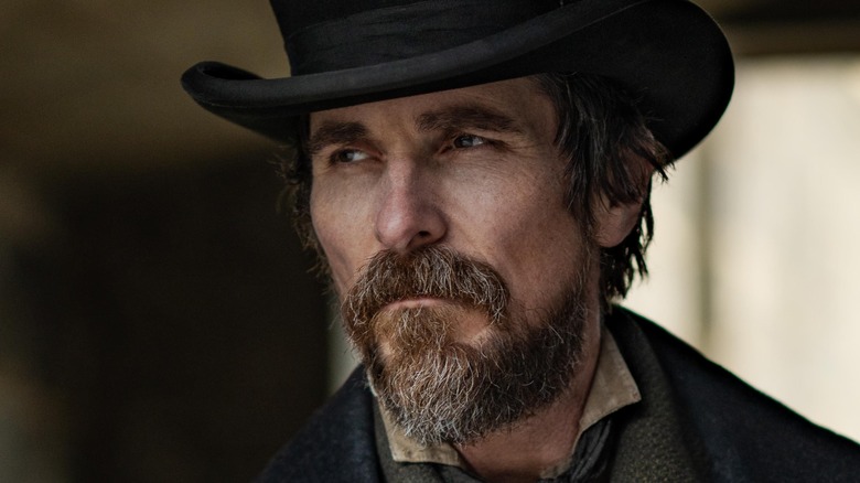 Christian Bale as Augustus Landor wearing a black hat in The Pale Blue Eye