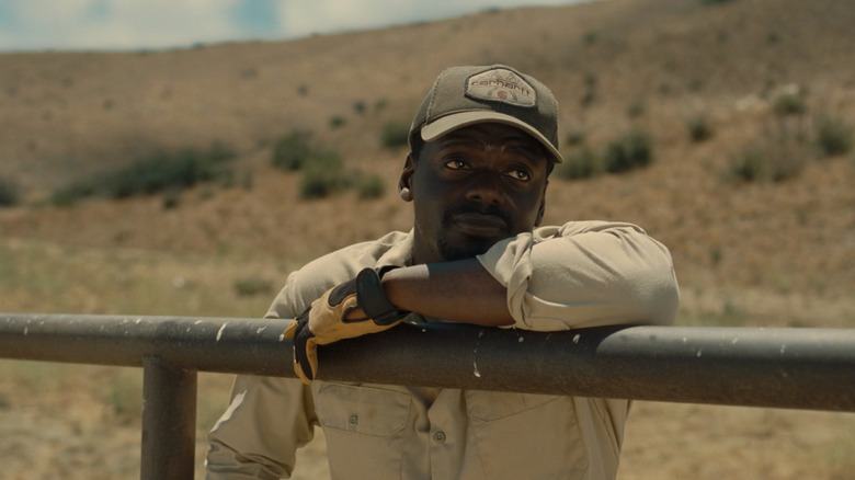 OJ leaning on fence