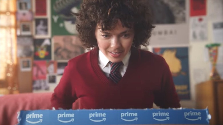 A young woman opens an Amazon box 