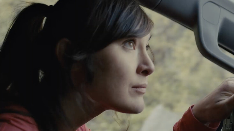 Woman wearing red top driving Chevy truck