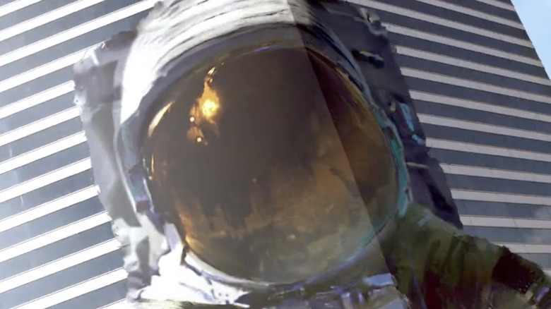 Astronaut draped across a building