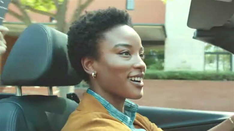 Woman smiling while driving convertible