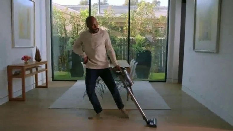 Man dancing while vacuuming