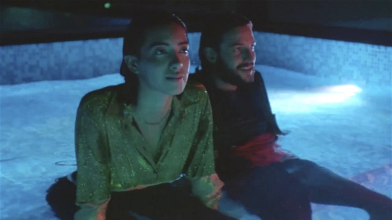 Zillow couple sitting in fancy pool