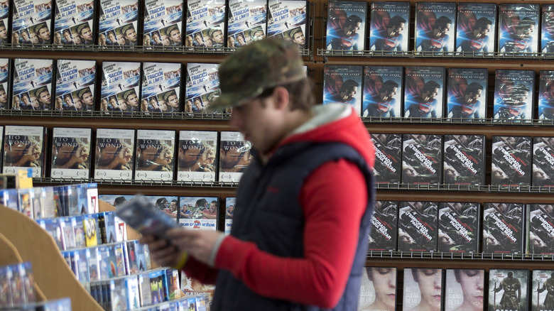 Customer browses video store titles