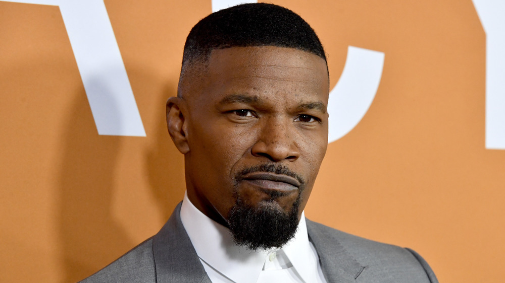 Jamie Foxx mugging for cameras at a premiere event