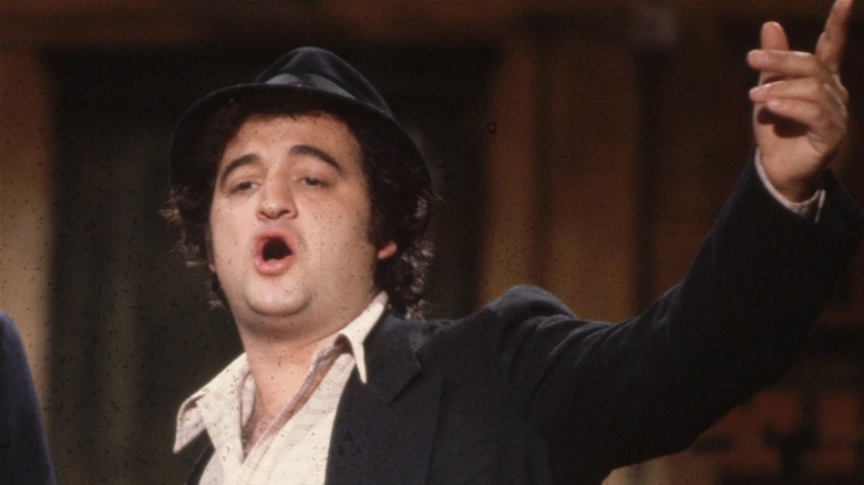 John Belushi raising hand