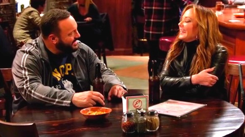 Kevin James and Leah Remini sitting at table