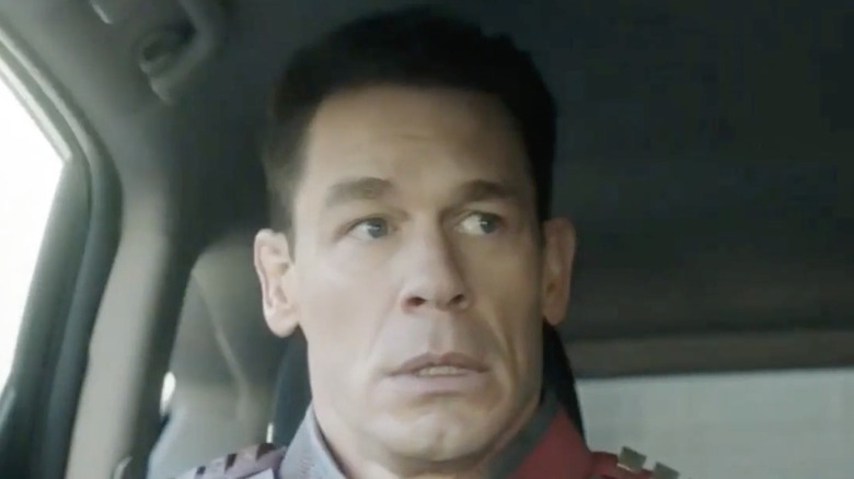 Christopher Smith (aka Peacemaker) (John Cena) frowns inside car in "Peacemaker"