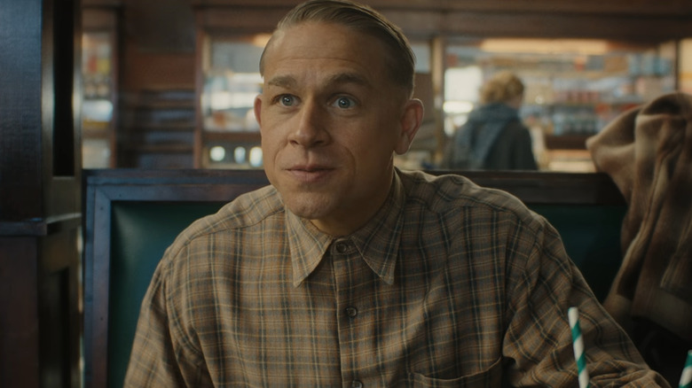 Ed Gein sitting at table in Monster: The Ed Gein Story