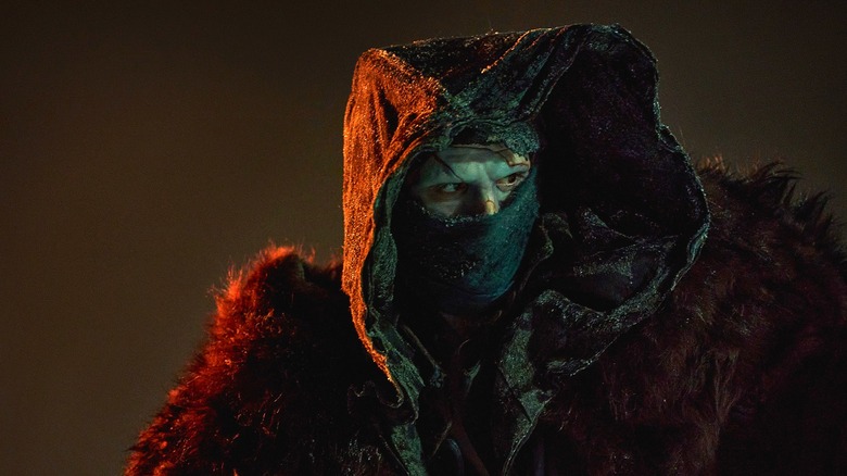 The Creature cloaked in a woolly coat in Frankenstein (2025)