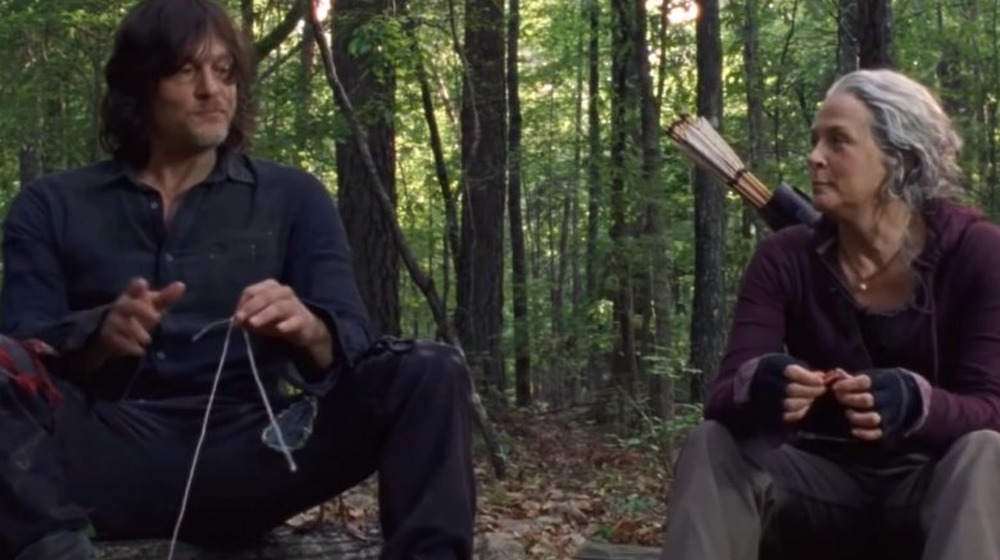 Daryl and Carol eat at campfire