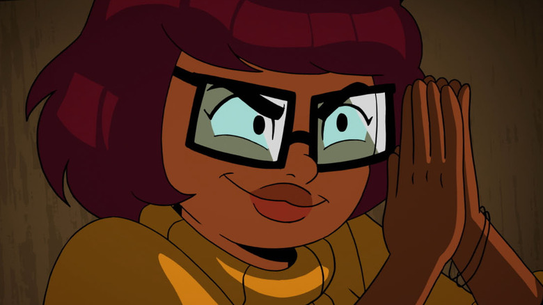 Velma smirking with hands together