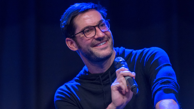 Tom Ellis in glasses smiling
