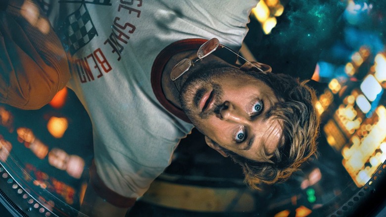 Dr. Ryland Grace looking through a porthole in 