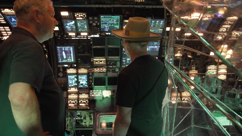 Adam Savage touring the spaceship interior, looking at screens in "Project Hail Mary"