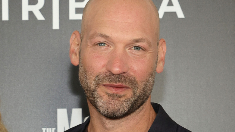 Corey Stoll smiling gray background