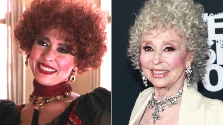 madame smiling curly red hair/rita moreno smiling white jacket