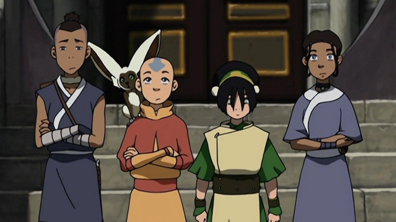 Sokka, Momo, Aang, Toph, and Katara standing in front of a staircase