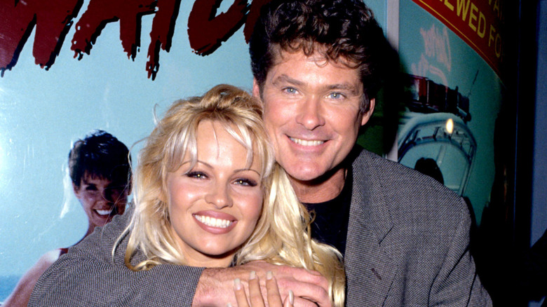 David Hasslehoff and Pamela Anderson in front of a "Baywatch" poster