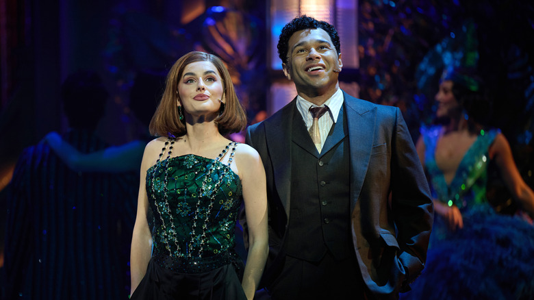 Amber Davies as Jordan Baker and Corbin Bleu as Nick Carraway look above in The Great Gatsby stage play.