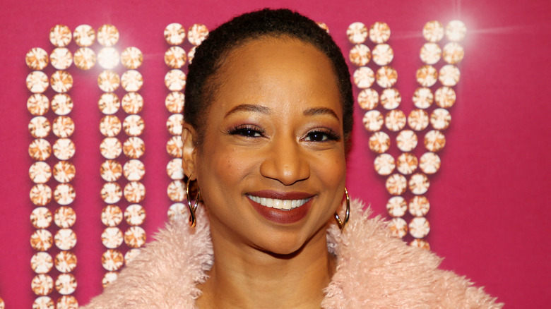 Monique Coleman smiles on the red carpet premiere of Romy & Michelle.