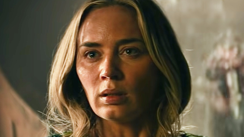 Emily Blunt scared with monster behind her