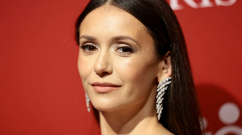 Nina Dobrev wearing diamond earrings