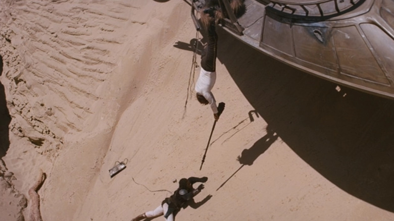 Han dangles from skiff