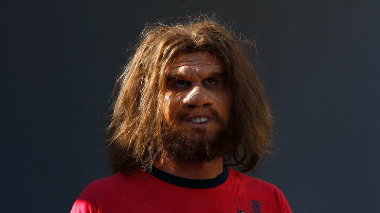 The Geico caveman in a red top